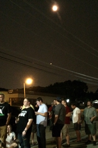 The hazy orange moon hangs over the line just before midnight at Burnt Hickory Brewing.