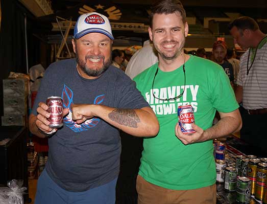 Chris Katechis of Oskar Blues shows off his tattoo in a photo with Porch Drinking staffer John Pylant