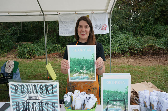 Double Dutch Press employee holds up favorite print offered at festival