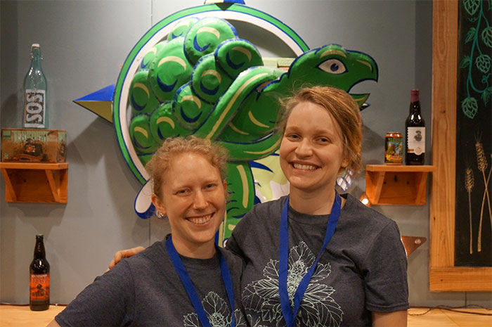 Two Terrapin employees smiling behind Gift Shop Counter