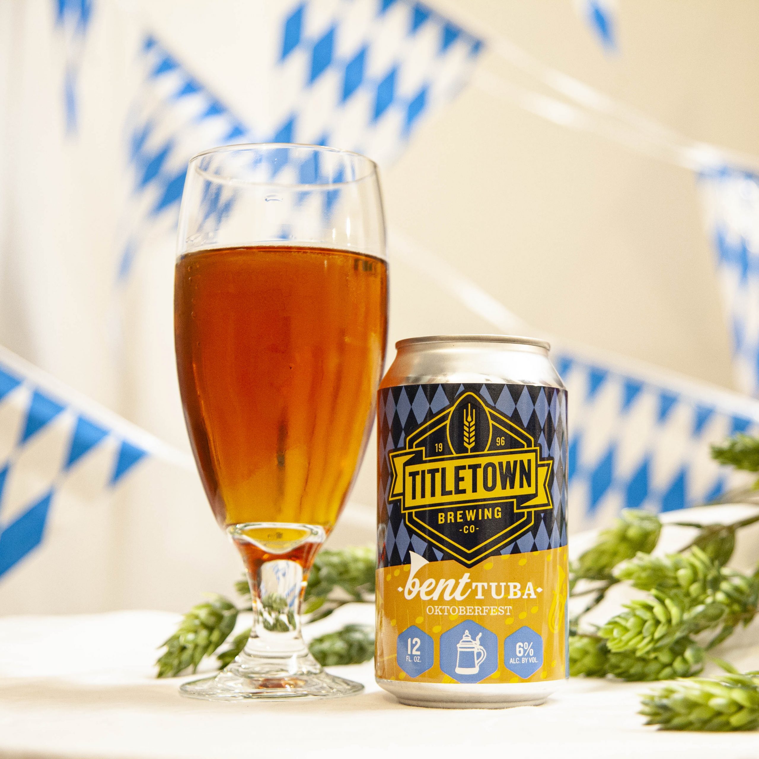 Titletown's Bent Tuba is poured into a stemmed chalice, amidst hop cones and white and blue bunting.