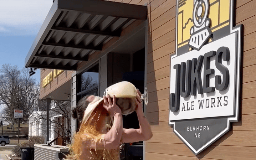 Man pours beer all over himself in front of Jukes Ale Works as part of an April Fool's Sketch