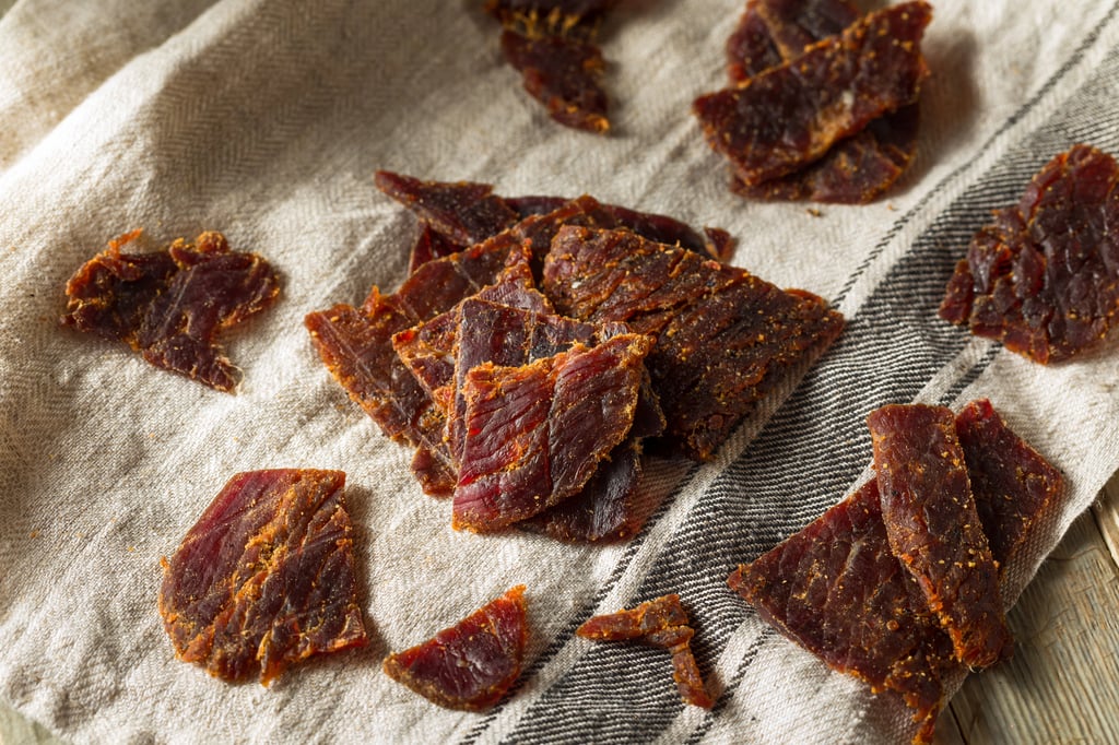 healthy beef jerky snack with beer on napkin