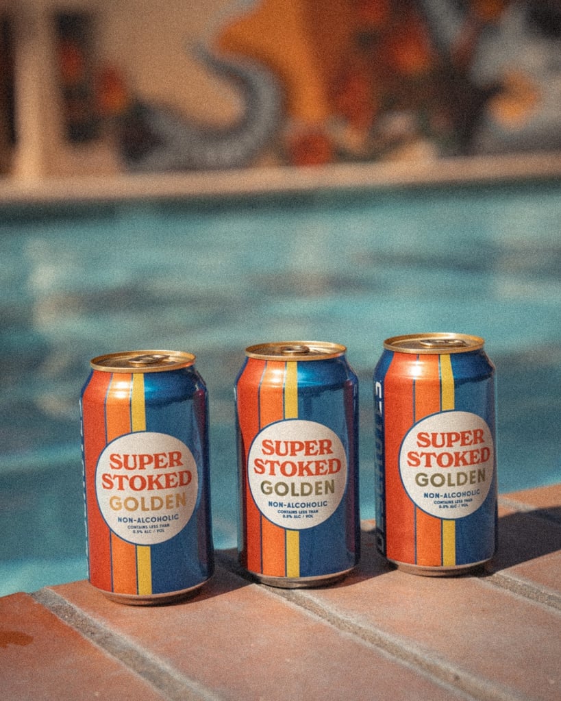 deschutes brewery super stoked golden non-alcoholic ale cans poolside