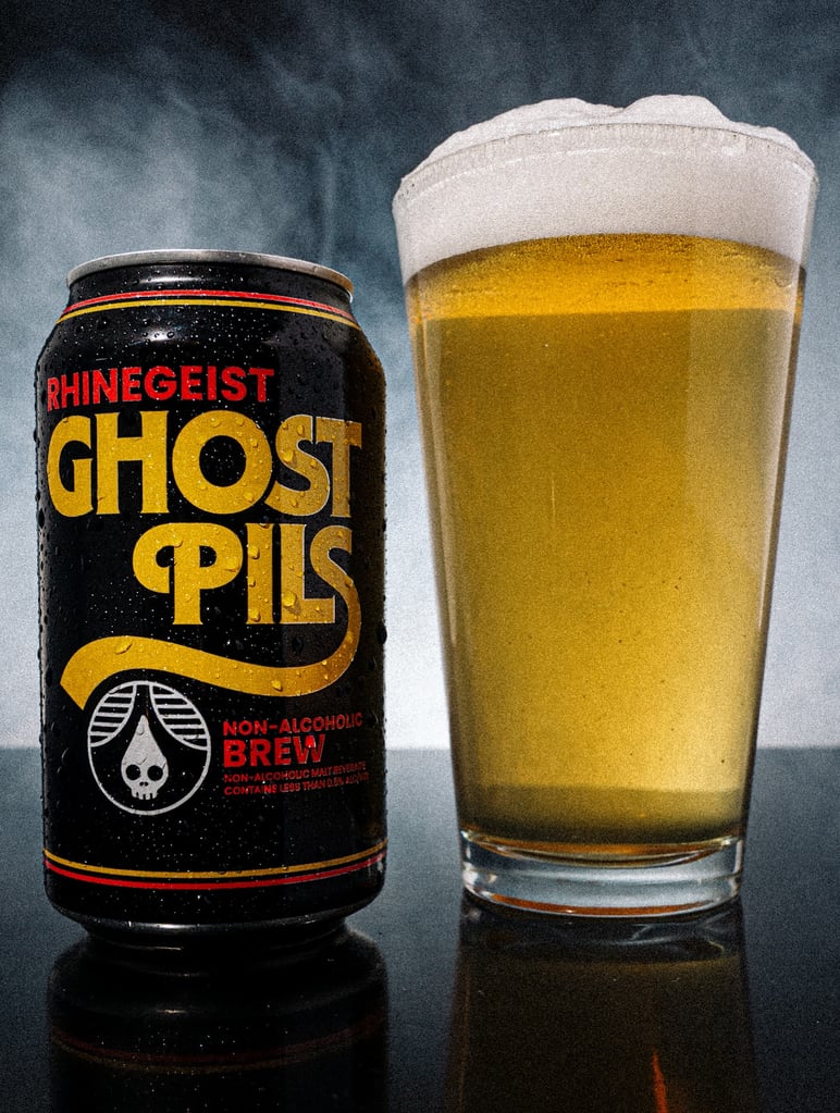 rhinegeist brewery ghost pils can and pint glass on smoky background
