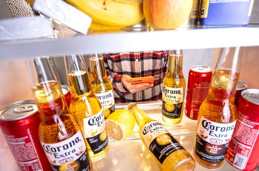 Corona Light bottles and cans inside a refrigerator.