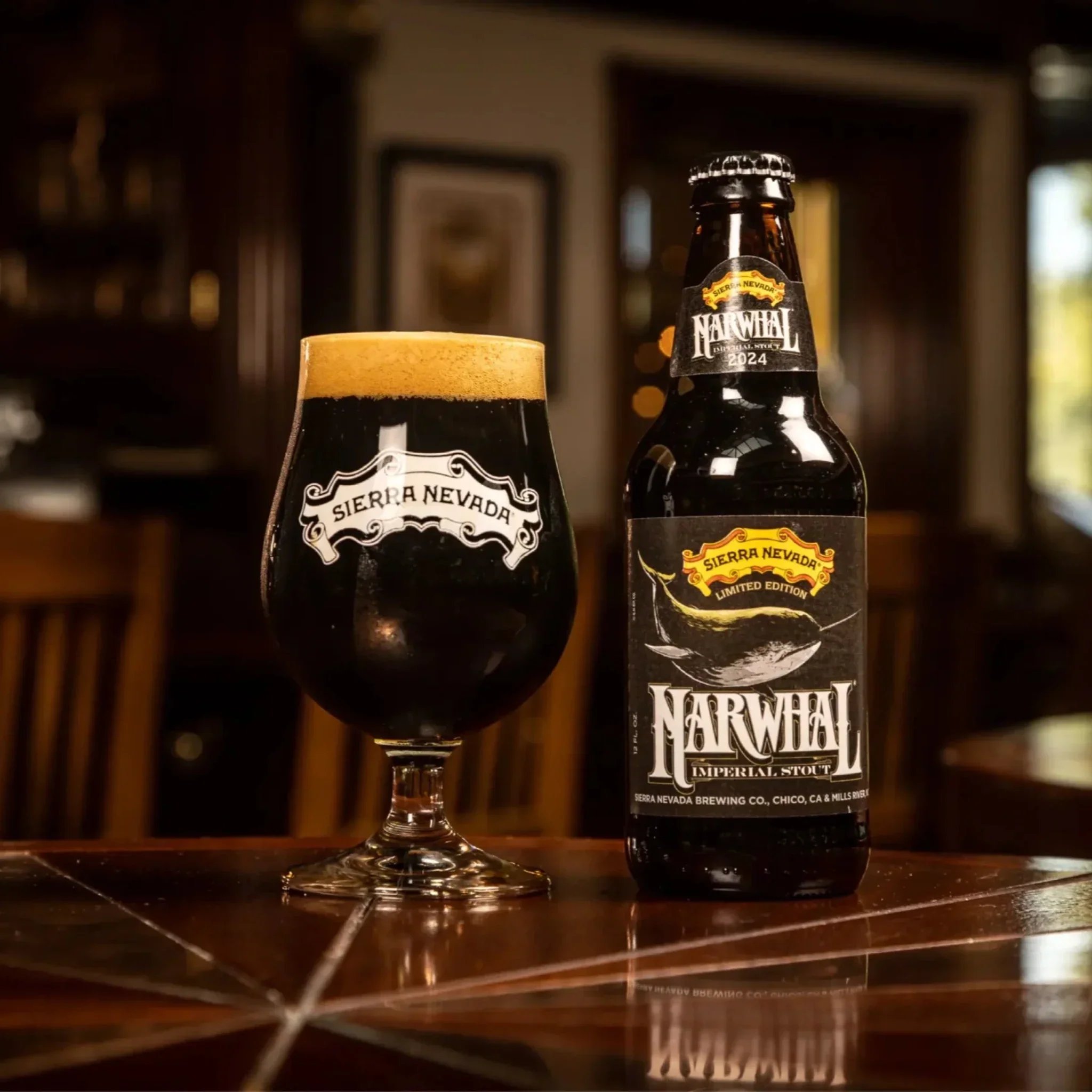 Sierra Nevada Narwhal Imperial Stout glass and bottle on a wooden table.