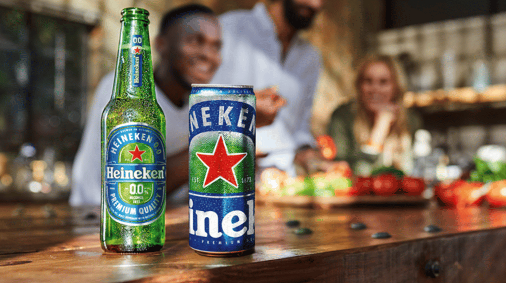 Heineken 0.0 bottle and glass on a wooden table.