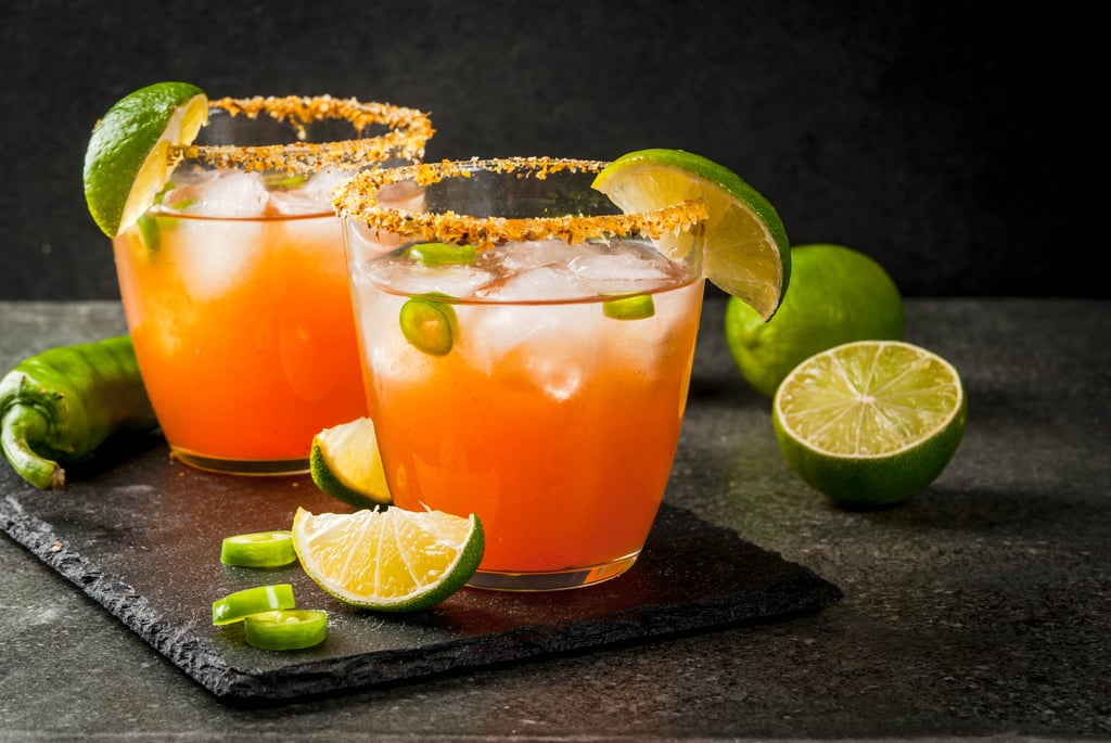 Mexican micheladas with lime slices and jalapeno