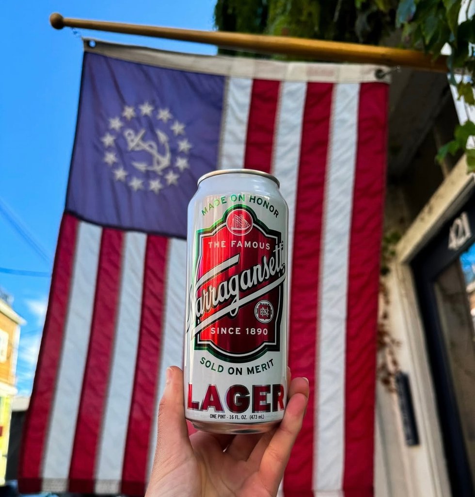 narragansett lager can in front of rhode island United States flag