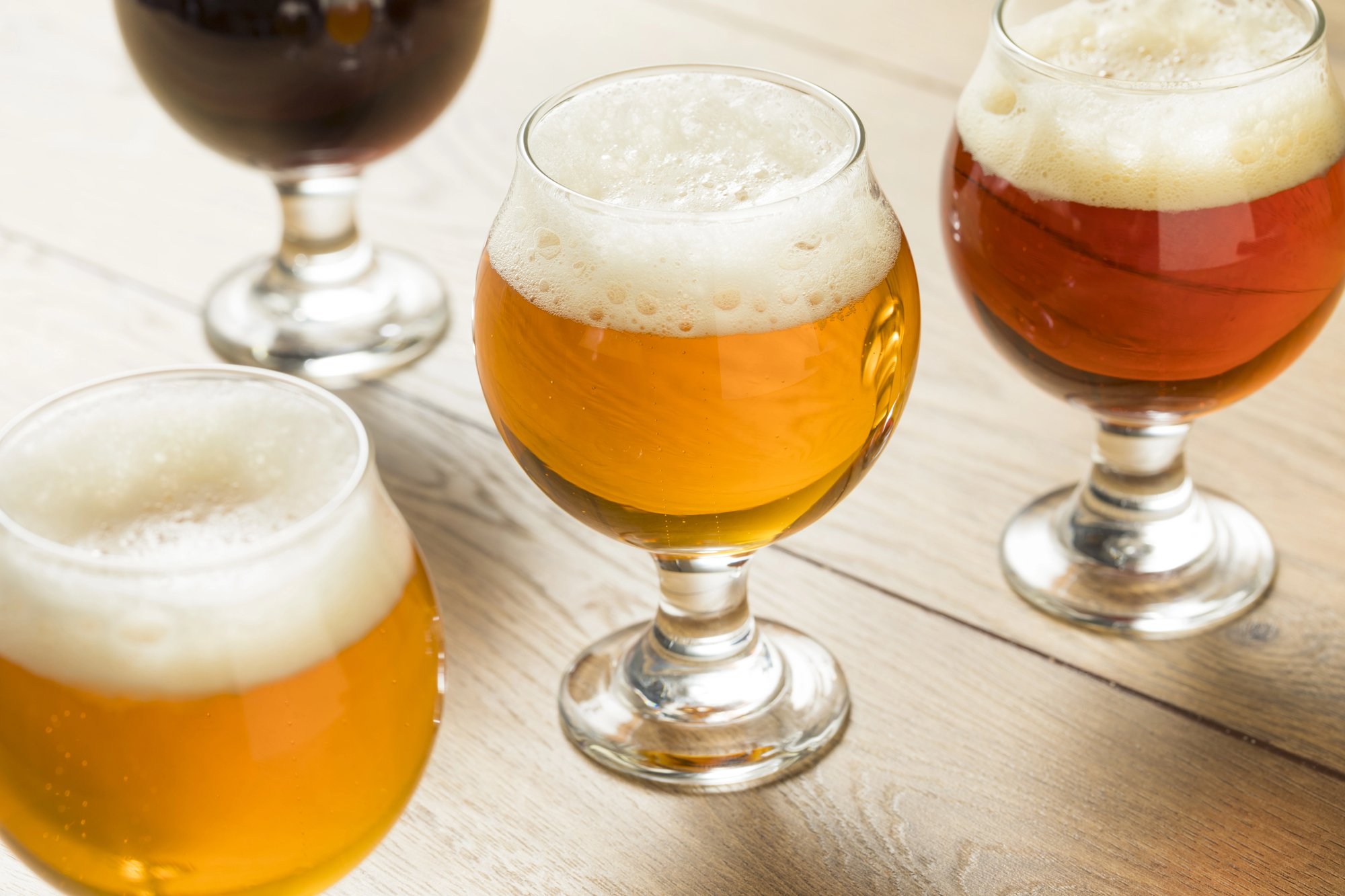 Flight of golden and amber beer on a table