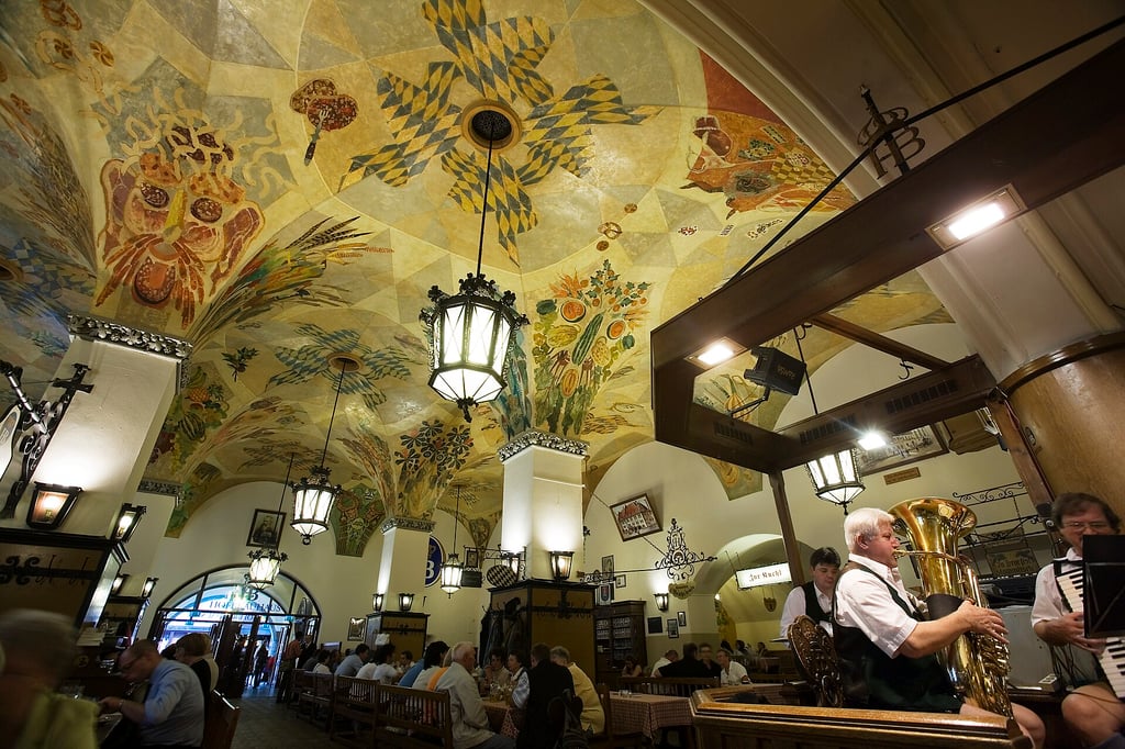 Lively interior of Hofbrauhaus in Munich, featuring decoratively painted ceilings.