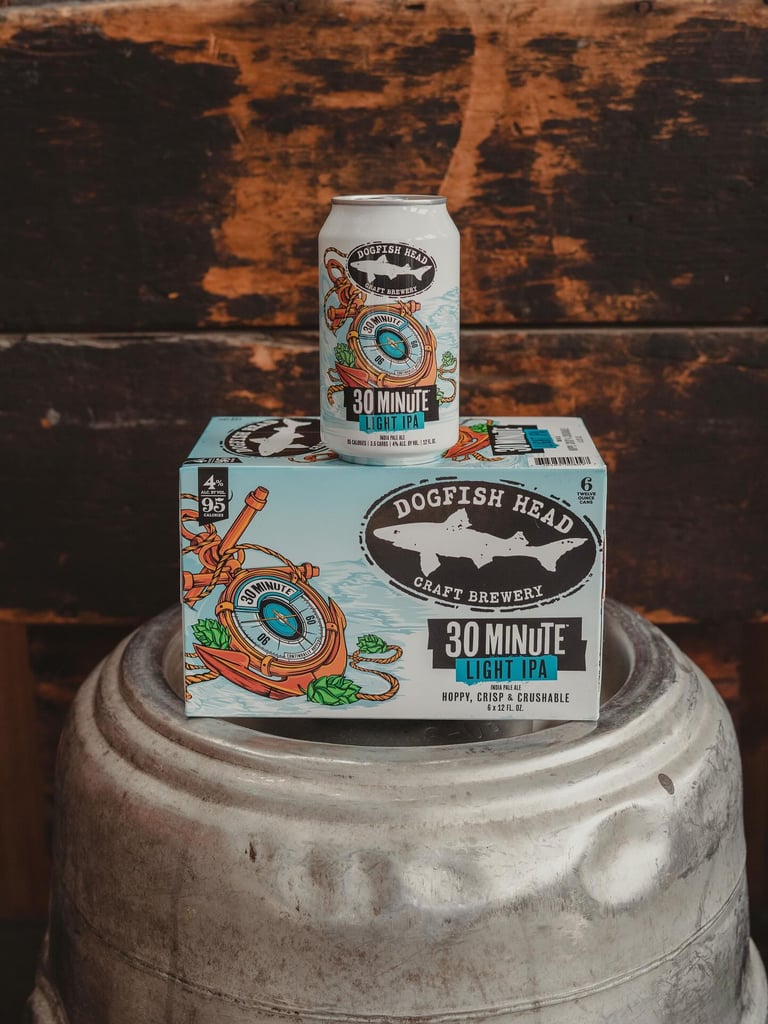 dogfish head 30 minute light ipa can and six-pack on top of keg