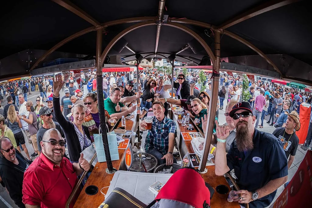 Crowd of people surrounding a bar