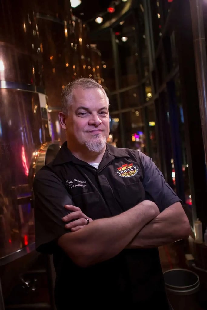 Portrait of man in front of brewing equipment