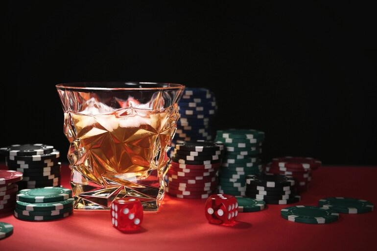 Beer glass surrounded by casino chips and dice representing online casino features for beer-loving players.