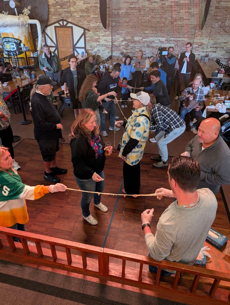 People taking part in the Cheese Curd Pull Competition