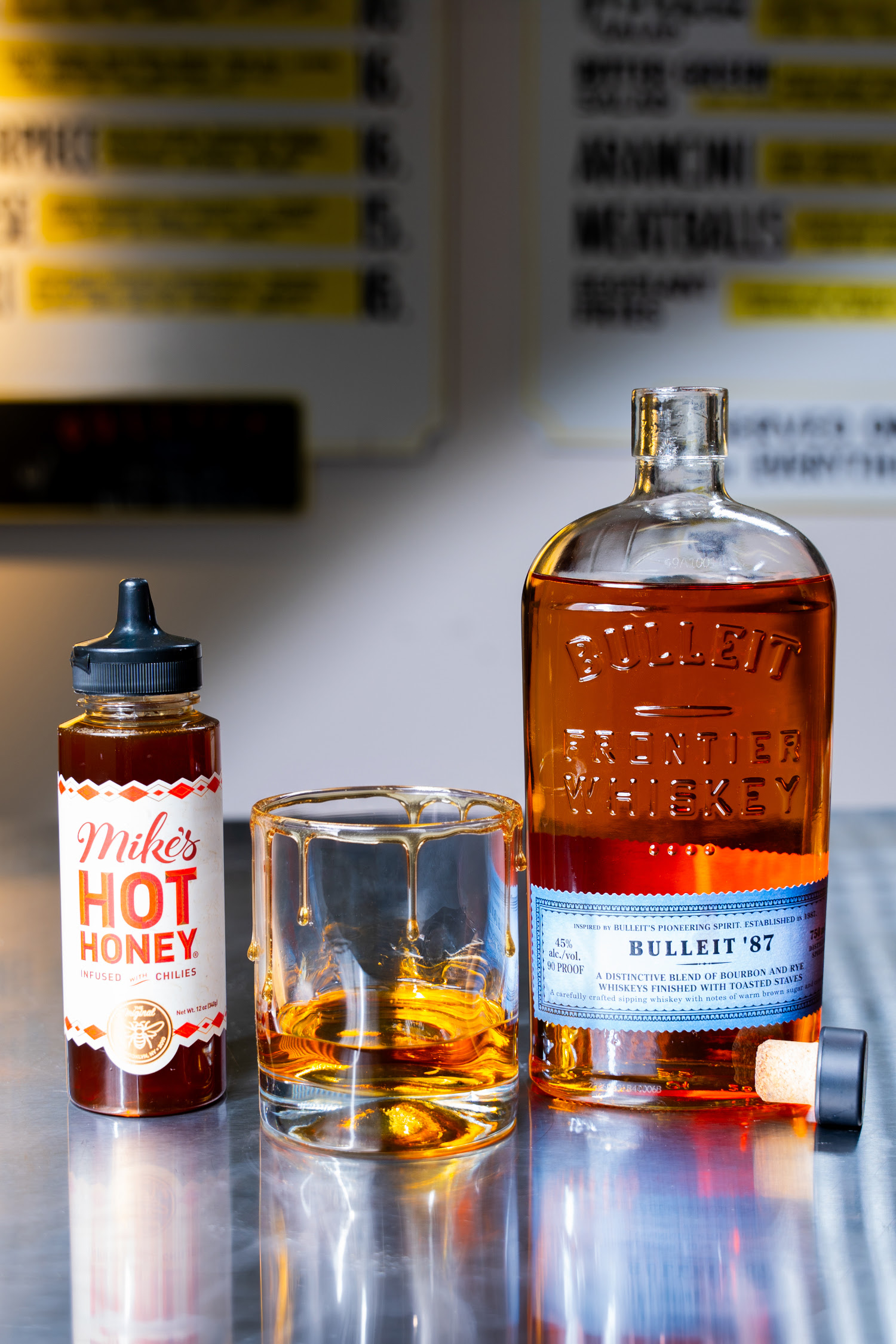 Bulleit 87 whiskey with Mike's Hot Honey rim