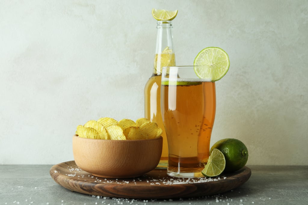 Chelada beer cocktail with lime juice and salt in a Mexican lager, served with snacks.