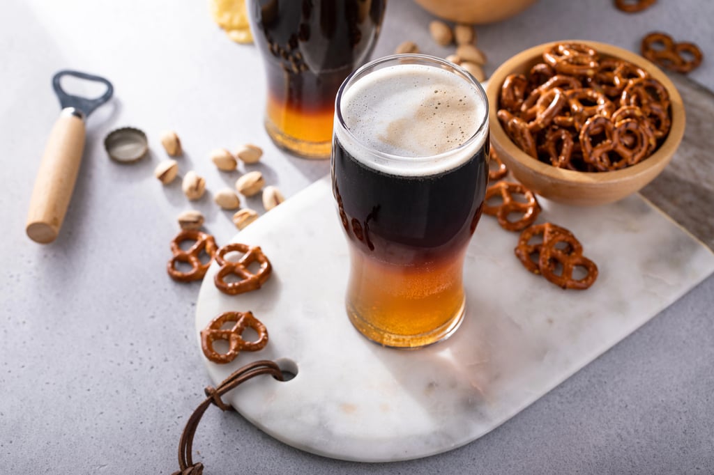 Black and tan beer cocktail with pale ale and dark stout beer.