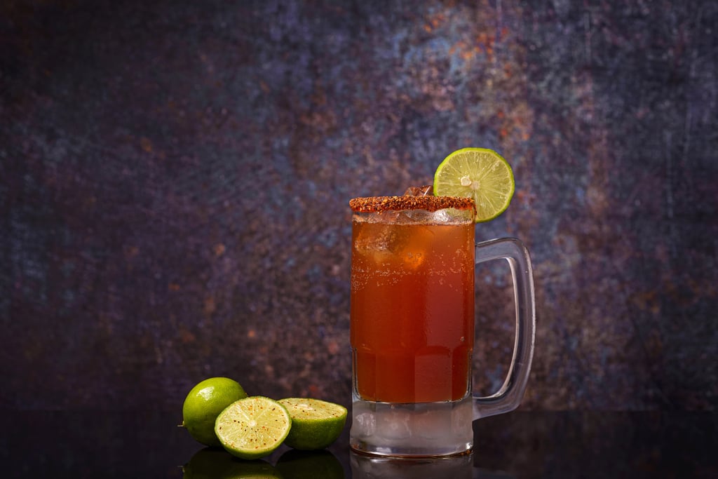 Classic michelada beer cocktail with lime, hot sauce, and tomato juice